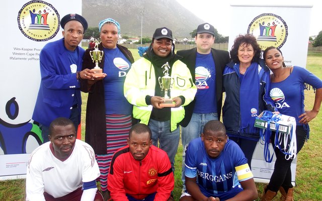Back fltr are Lindile Ntsabo (Zwelihle), Cllr Linda Ndevu (Masakhane), MP Masizole Mnqasela, Grant Cohen (Youth Overstrand Chairperson), Cllr Riana de Coning (Gansbaai) and Ntsiki Siwela (Zwelihle). In the front row is the team captains and match officials.